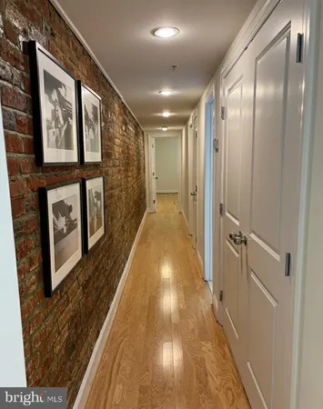 a view of a hallway with wooden floor