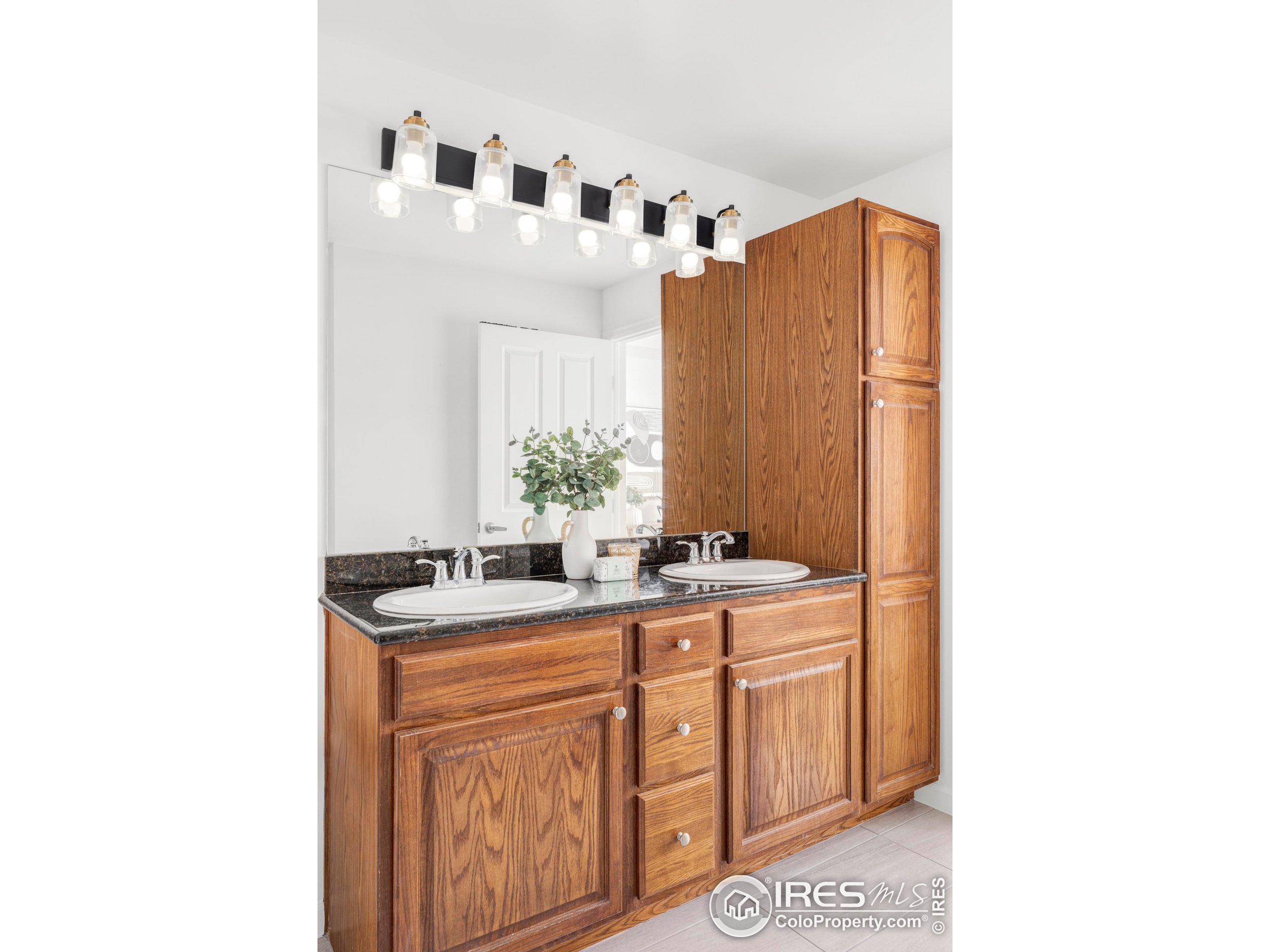 1950 Logan Street, Unit 1013 Denver, CO 80203 - Photo 18 of 23 a bathroom with a sink and a mirror