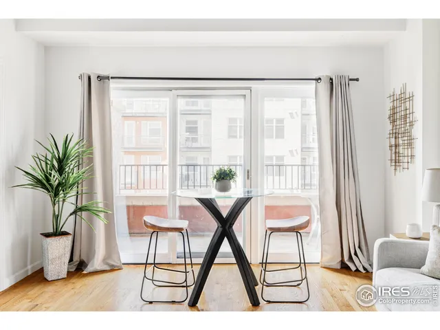 a living room with a couch and a potted plant