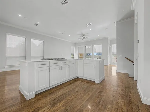 a kitchen with white cabinets and white appliances