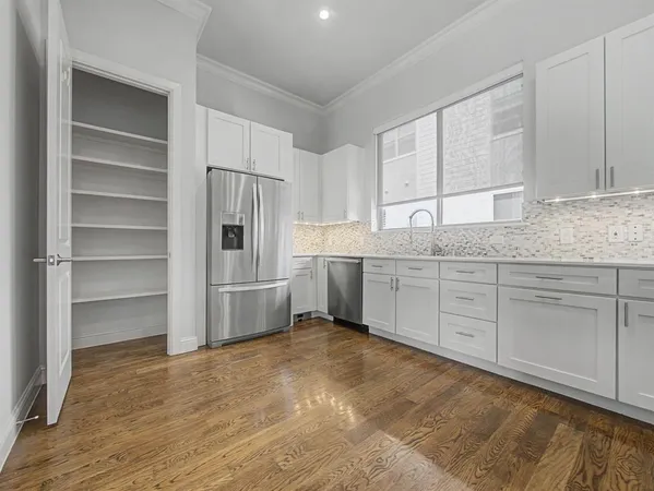 a kitchen with granite countertop a cabinets and white stainless steel appliances
