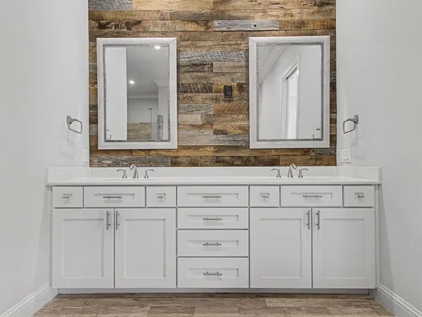 a bathroom with cabinets sink and vanity