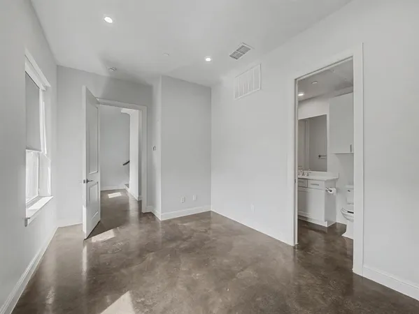 a view of an empty room and a bathroom