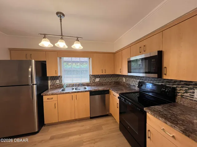 a view of a kitchen with a sink and a window