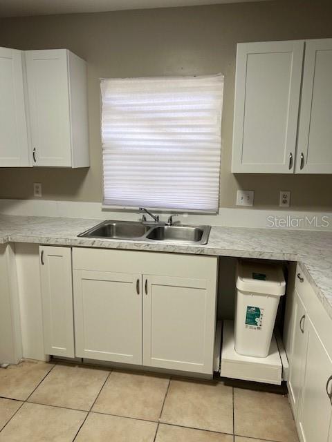 3122 Southwest 26th Terrace, Unit B Gainesville, FL 32608 - Photo 12 of 13 a kitchen with granite countertop white cabinets and white appliances