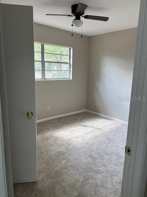 3122 Southwest 26th Terrace, Unit B Gainesville, FL 32608 - Photo 5 of 13 an empty room with windows and fan