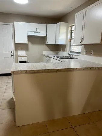 a kitchen with stainless steel appliances granite countertop a sink a stove a refrigerator a microwave and cabinets