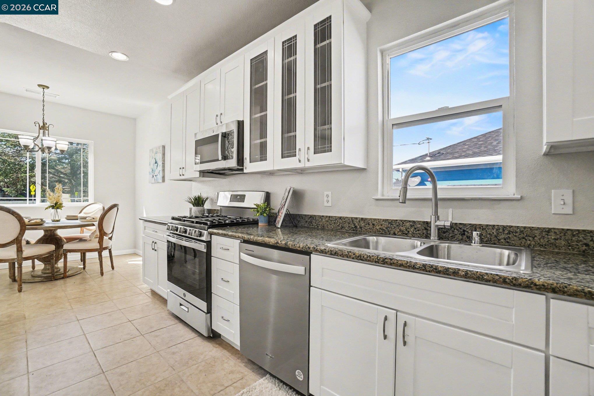 139 Rodeo Avenue Rodeo, CA 94572 - Photo 6 of 19 a kitchen with granite countertop a sink stove and cabinets