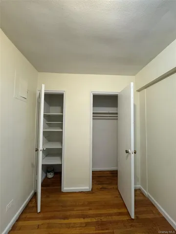 a view of walk in closet with empty racks