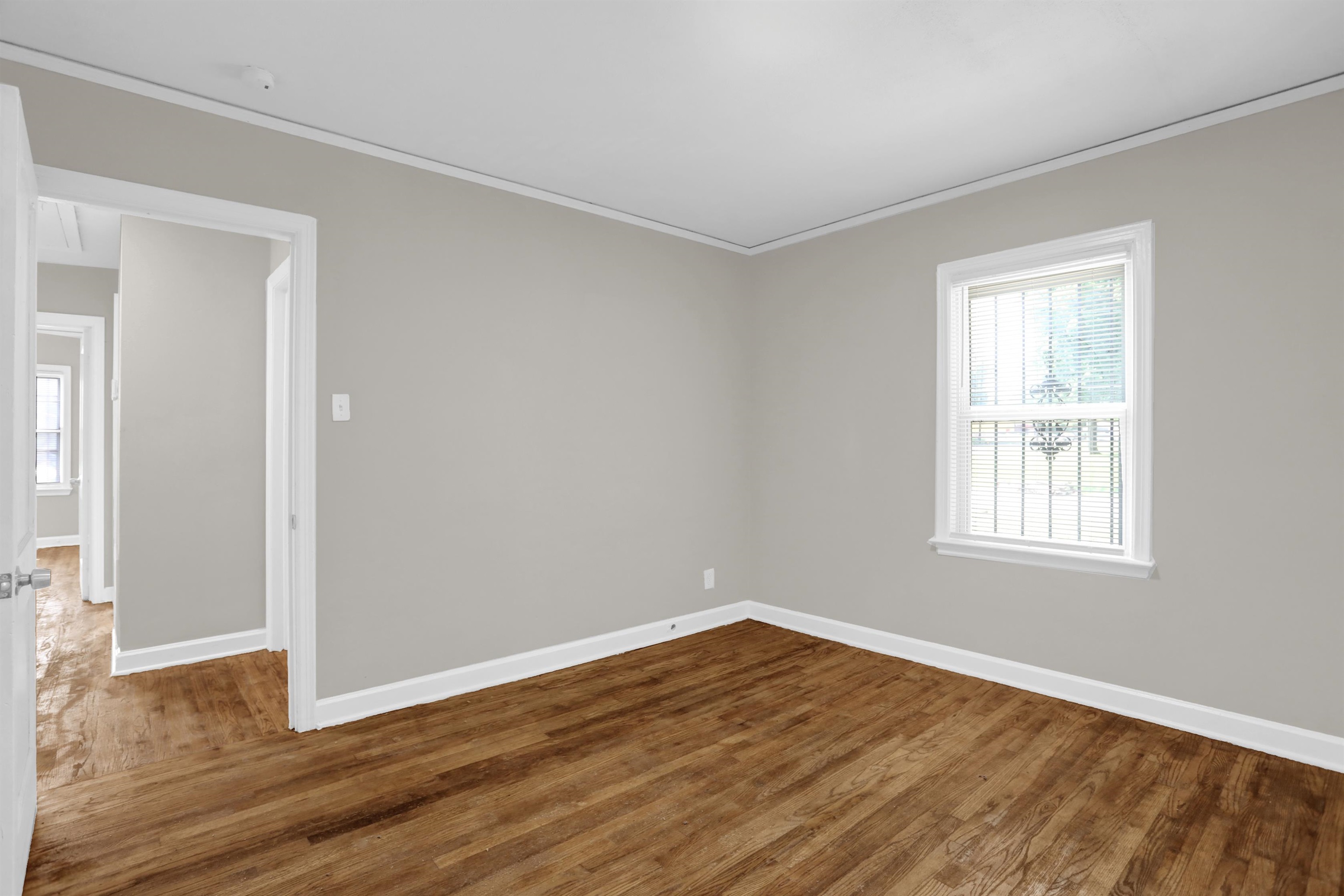 3257 Millington Road Memphis, TN 38127 - Photo 12 of 31 Spare room with ornamental molding, dark wood finished floors, and healthy amount of natural light