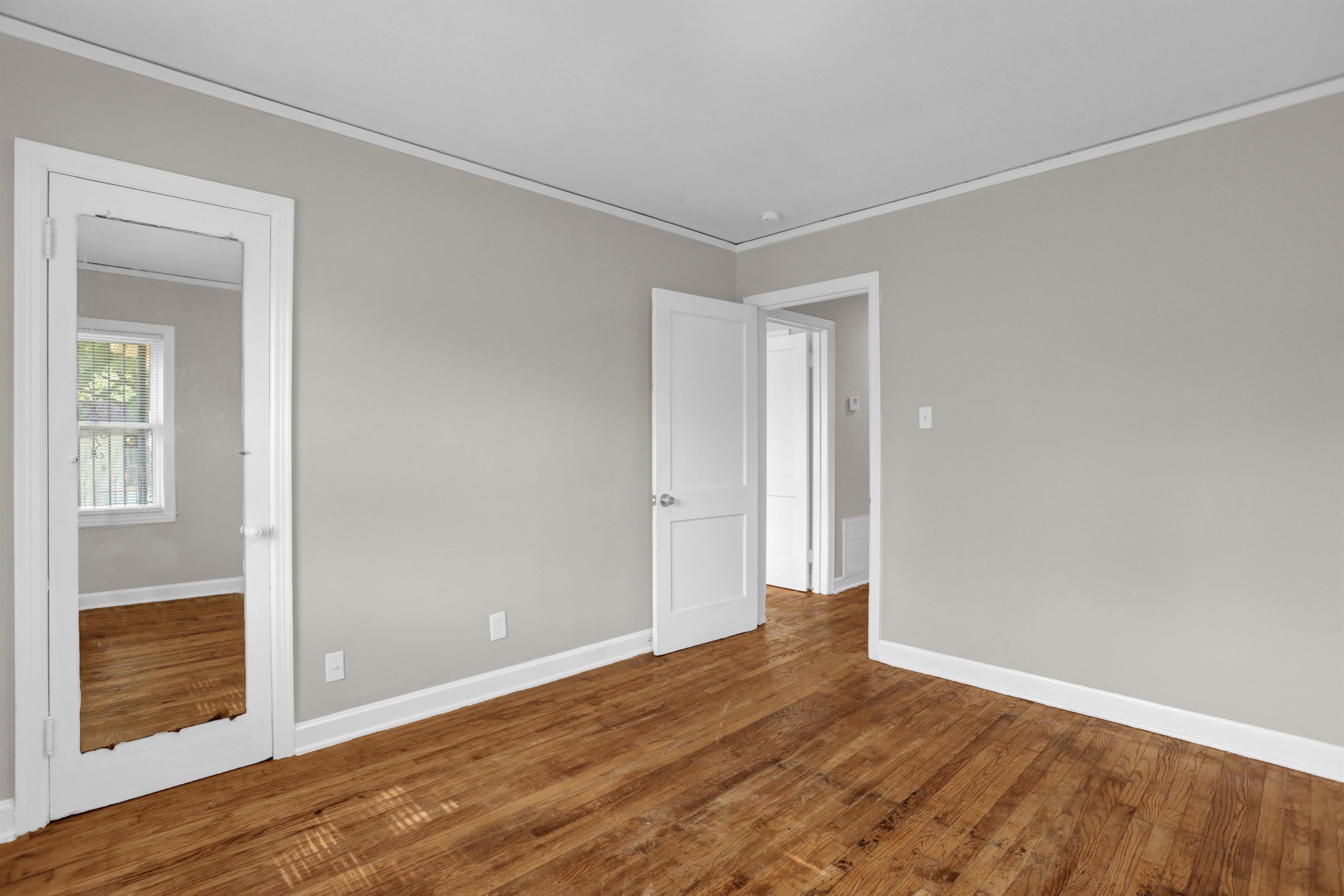 3257 Millington Road Memphis, TN 38127 - Photo 4 of 31 Empty room with ornamental molding and wood finished floors