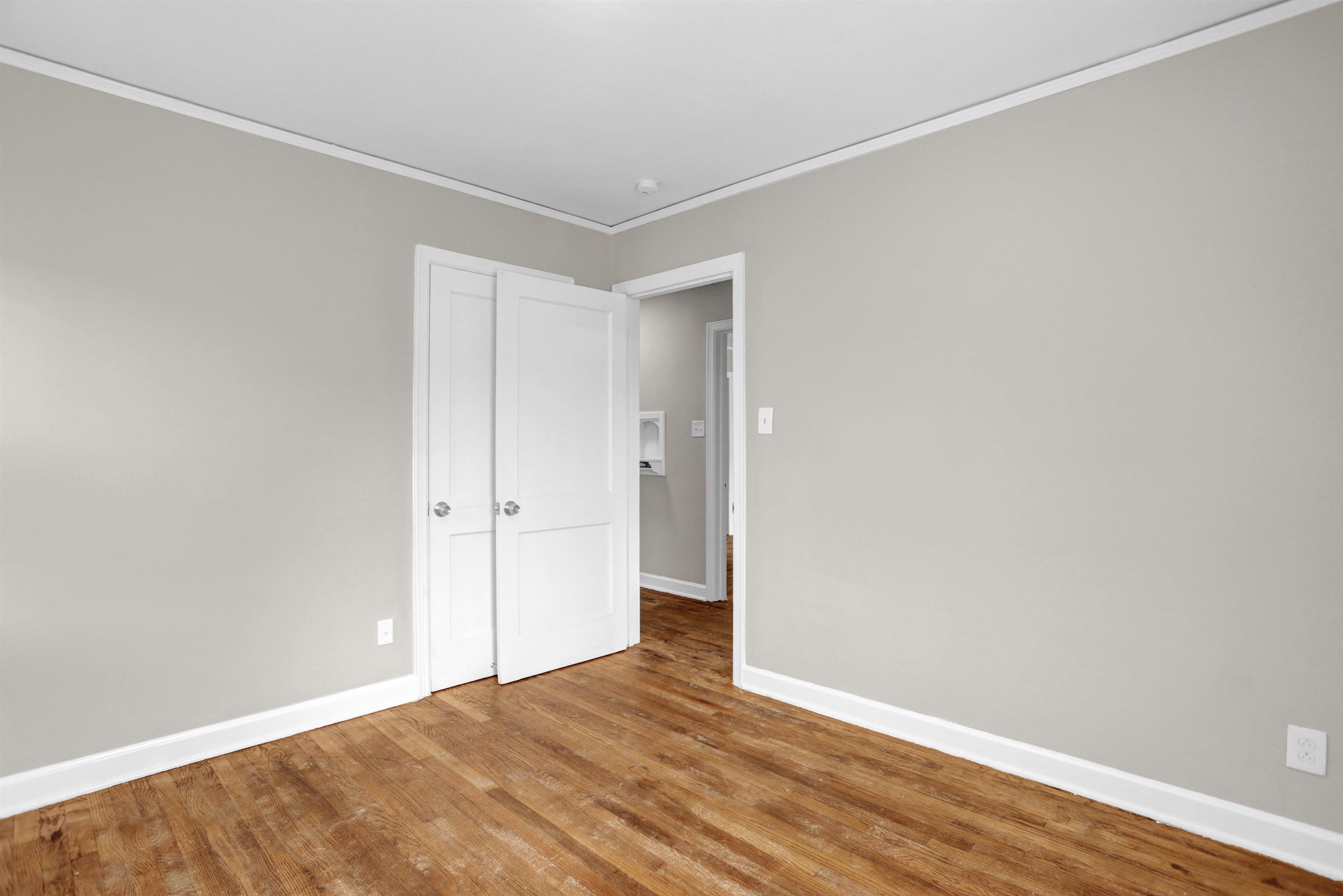 3257 Millington Road Memphis, TN 38127 - Photo 7 of 31 Unfurnished bedroom featuring wood finished floors, ornamental molding, and a closet