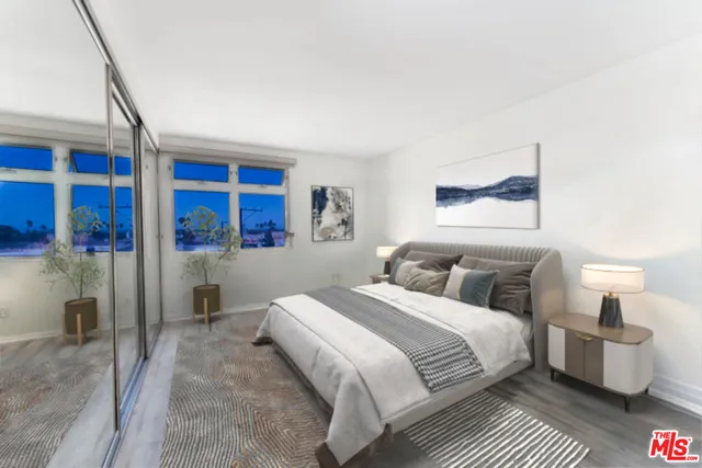 a bedroom with a large bed and a window