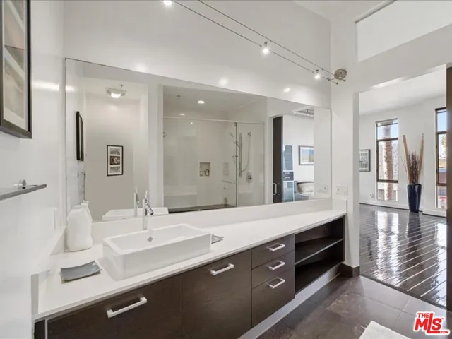 a large room with a bed and flat tv screen