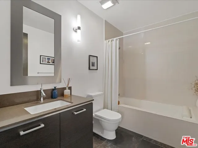 a spacious bedroom with a bed and a large window