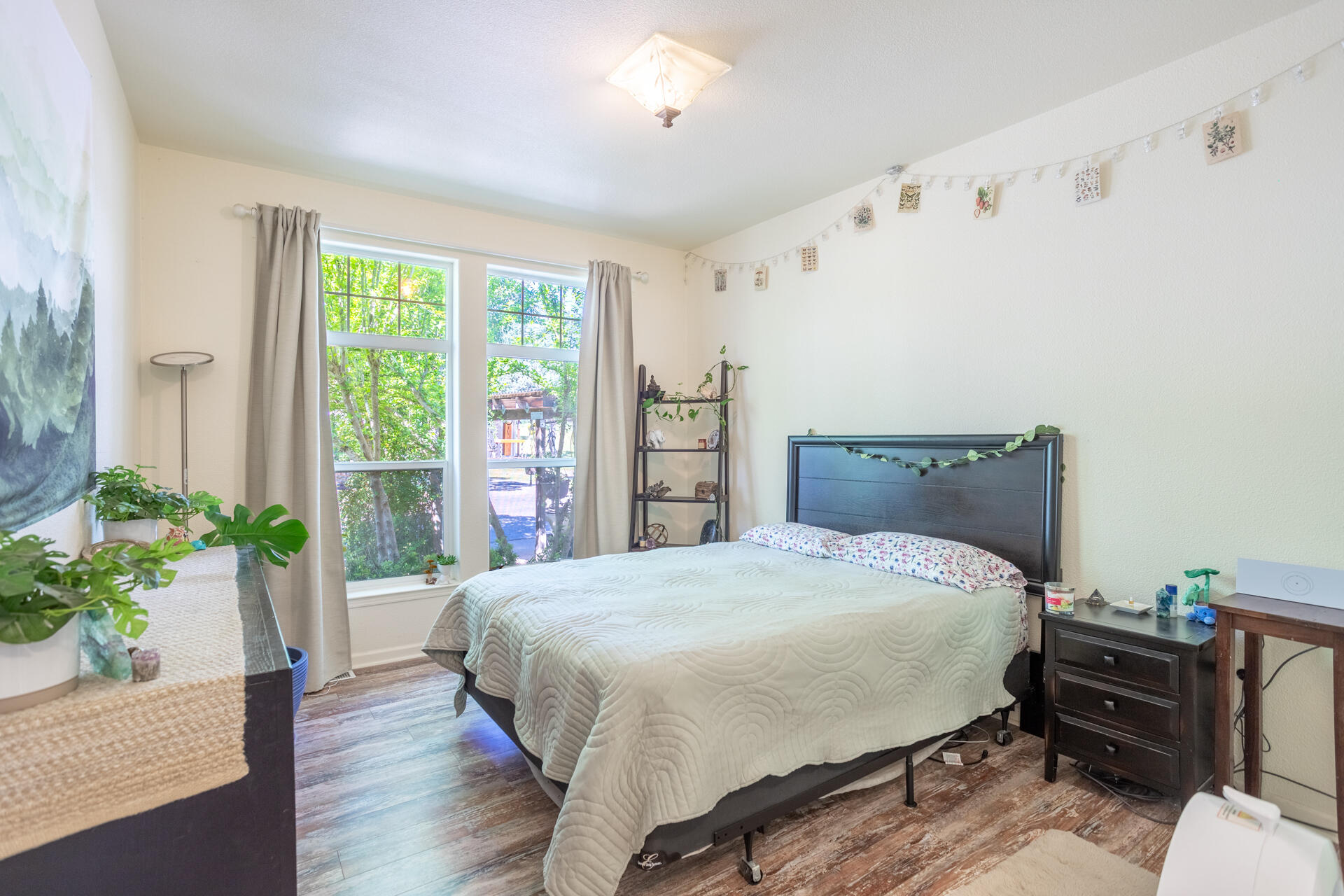 21100 Doe Run Way Red Bluff, CA 96080 - Photo 27 of 93 a bedroom with a bed table flowerpot and window