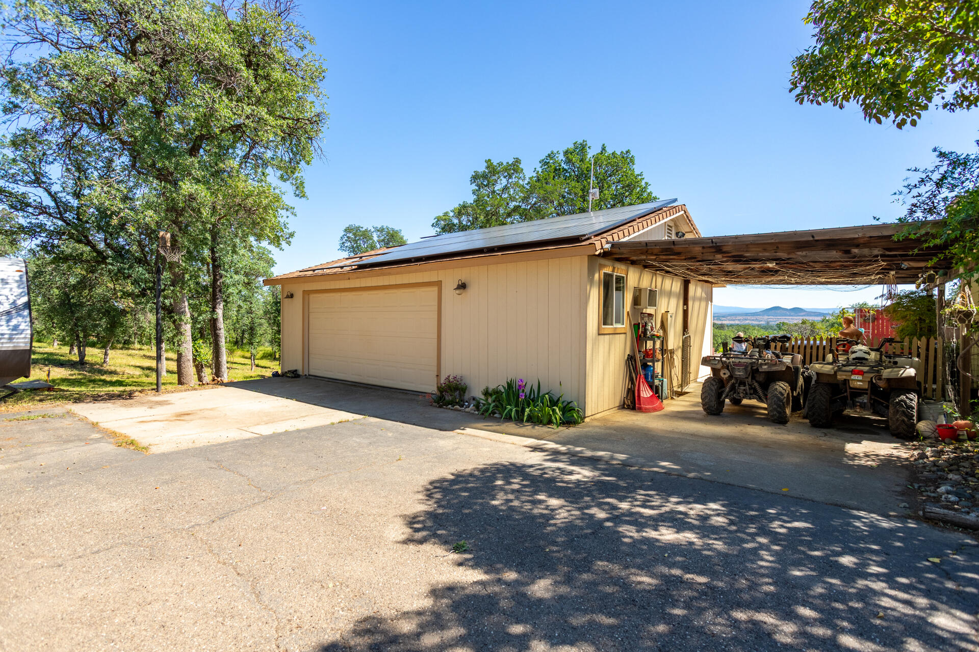21100 Doe Run Way Red Bluff, CA 96080 - Photo 39 of 93 a view of a patio with a table and chairs under an umbrella