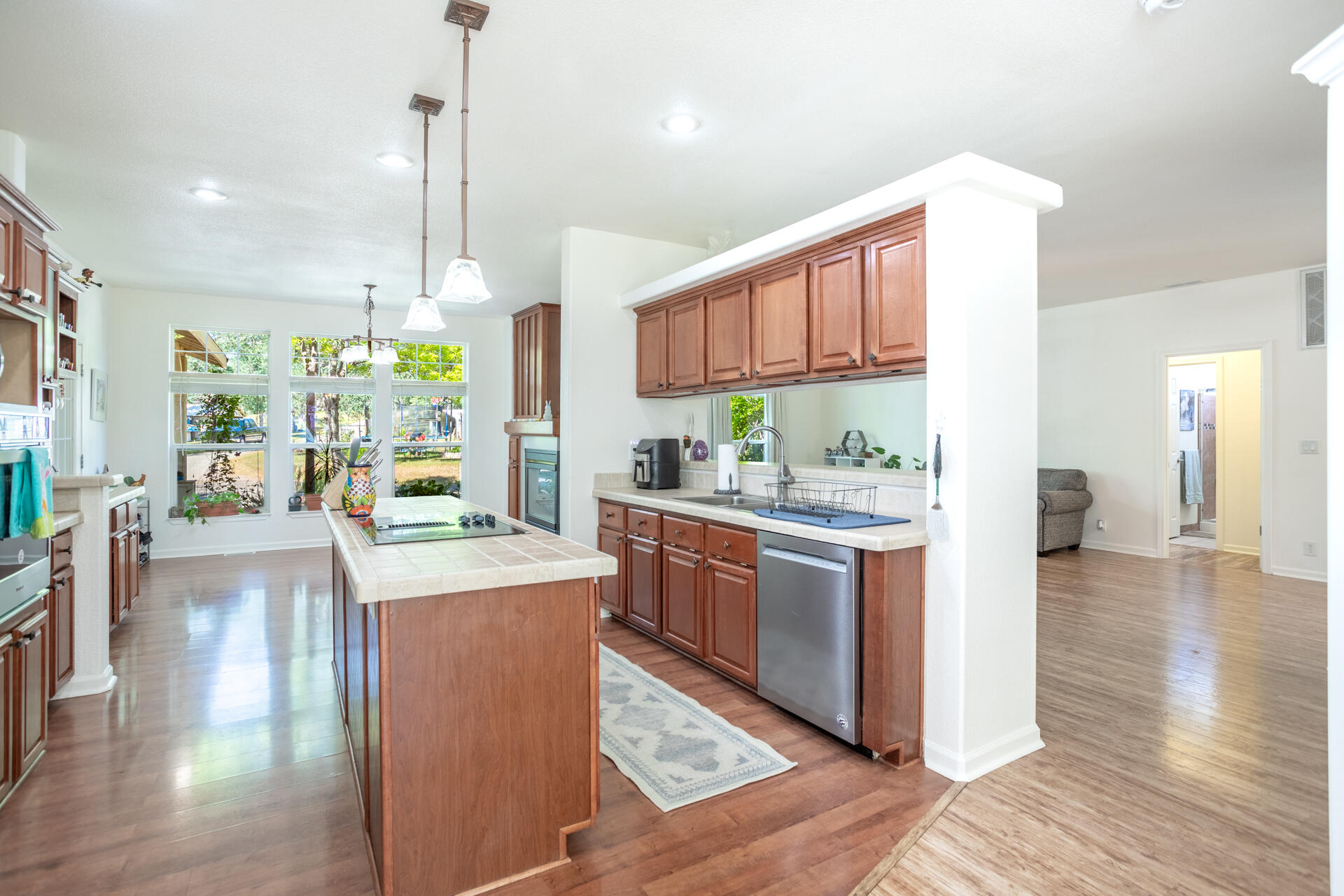 21100 Doe Run Way Red Bluff, CA 96080 - Photo 8 of 93 a kitchen with stainless steel appliances granite countertop wooden floors a stove a sink and a wooden floors