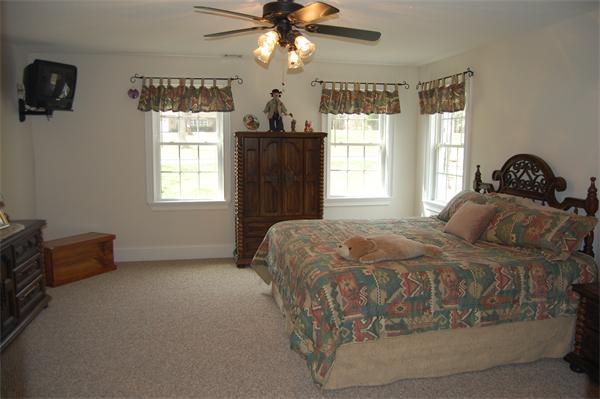 49 Old Gilbertville Road Ware, MA 01082 - Photo 12 of 25 a bedroom with a bed and a chandelier