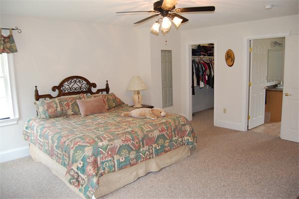 49 Old Gilbertville Road Ware, MA 01082 - Photo 13 of 25 a bedroom with a bed and a chandelier