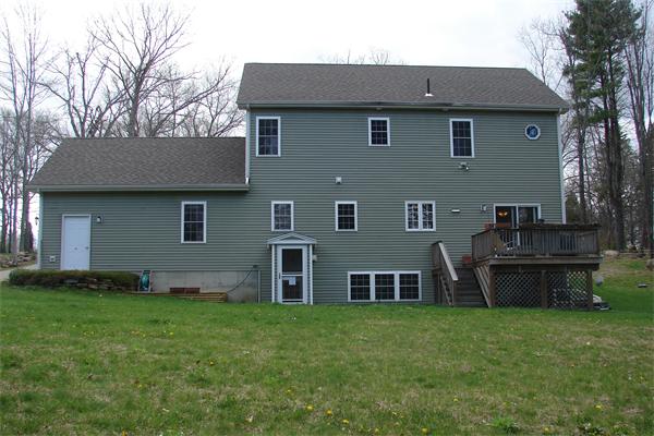 49 Old Gilbertville Road Ware, MA 01082 - Photo 25 of 25 a brick house with a yard plants and large tree