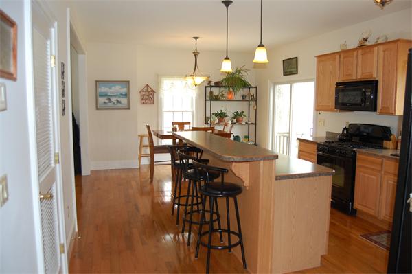 49 Old Gilbertville Road Ware, MA 01082 - Photo 4 of 25 a view of a dining room and livingroom with furniture wooden floor a chandelier