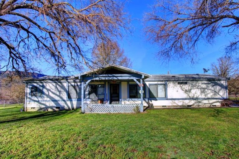 8085 High Banks Road Central Point, OR 97502 - Photo 1 of 35 a front view of a house with garden
