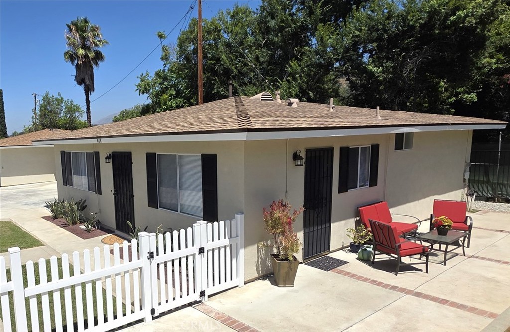 868 Random Lane Duarte, CA 91010 - Photo 18 of 22 a patio with table and chairs and potted plants with wooden floor and fence