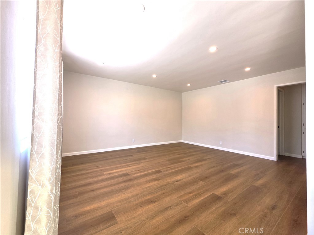 868 Random Lane Duarte, CA 91010 - Photo 7 of 22 a view of an empty room with wooden floor