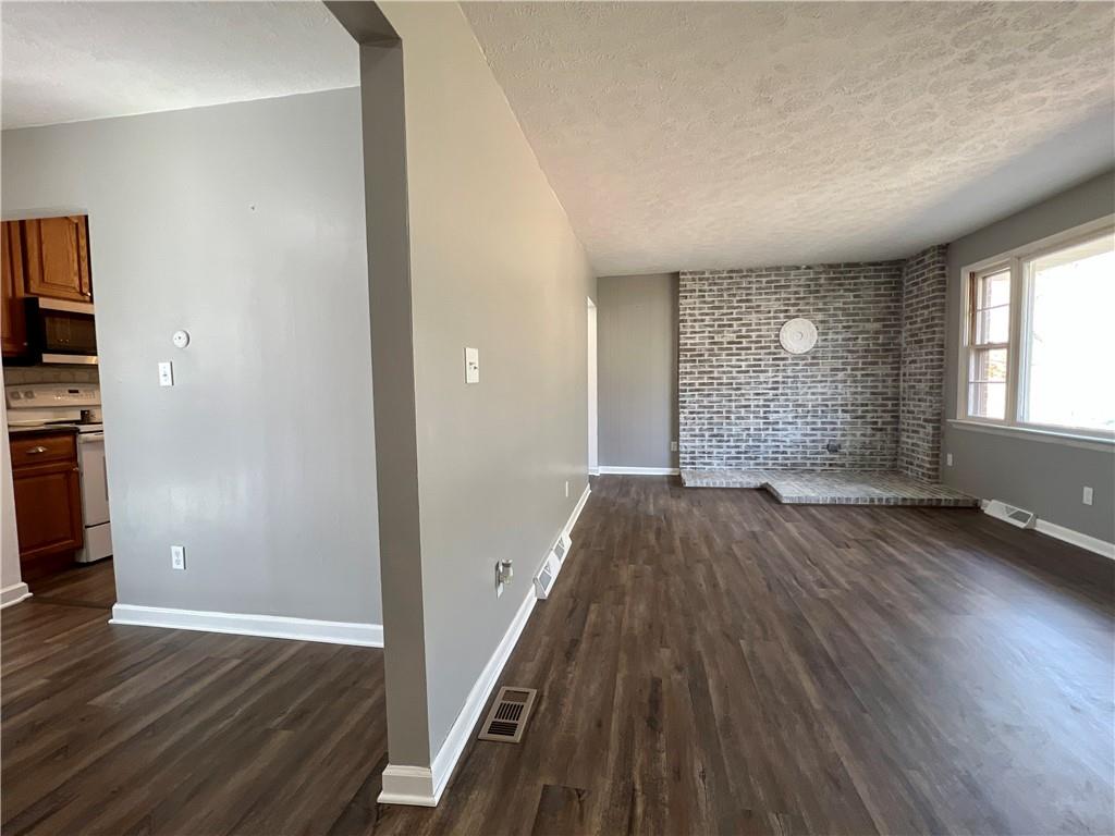 97 Dean Road Sandy Lake, PA 16145 - Photo 11 of 25 an empty room with wooden floor and windows