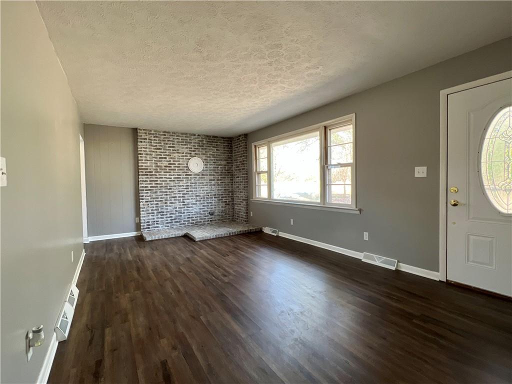 97 Dean Road Sandy Lake, PA 16145 - Photo 12 of 25 an empty room with wooden floor and windows