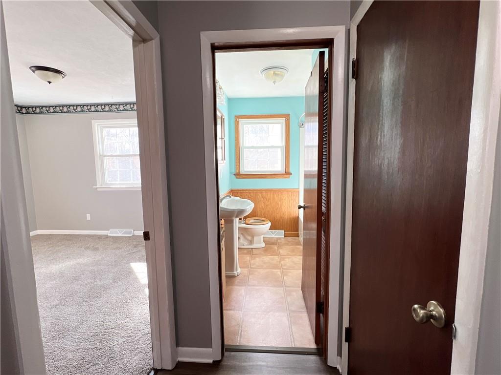 97 Dean Road Sandy Lake, PA 16145 - Photo 17 of 25 a view of a bathroom with a glass door