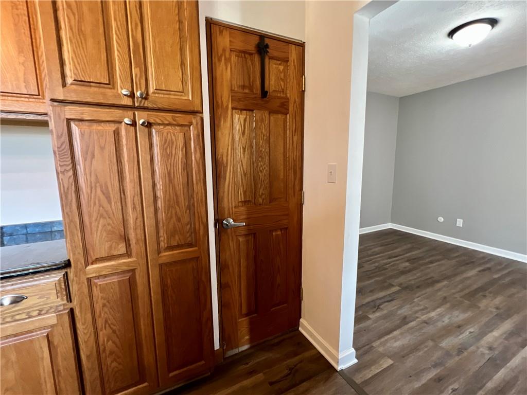 97 Dean Road Sandy Lake, PA 16145 - Photo 6 of 25 an empty room with wooden floor