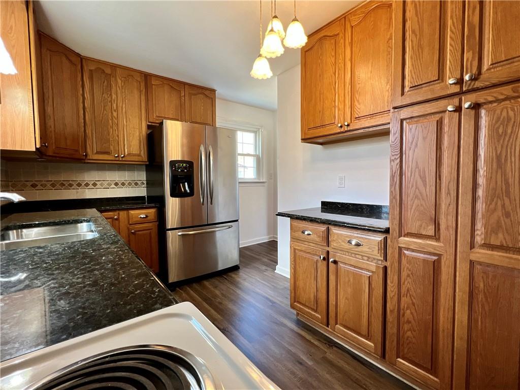 97 Dean Road Sandy Lake, PA 16145 - Photo 9 of 25 a kitchen with stainless steel appliances granite countertop a refrigerator a stove and a sink with cabinets