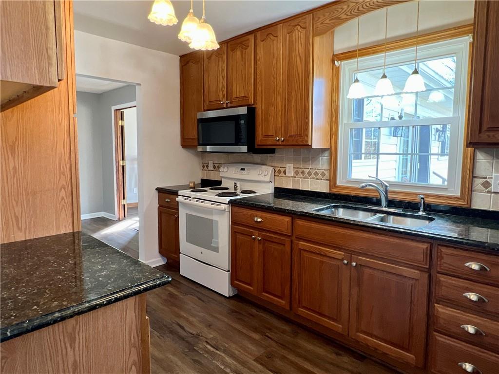 97 Dean Road Sandy Lake, PA 16145 - Photo 10 of 25 a kitchen with stainless steel appliances granite countertop a sink a stove and cabinets