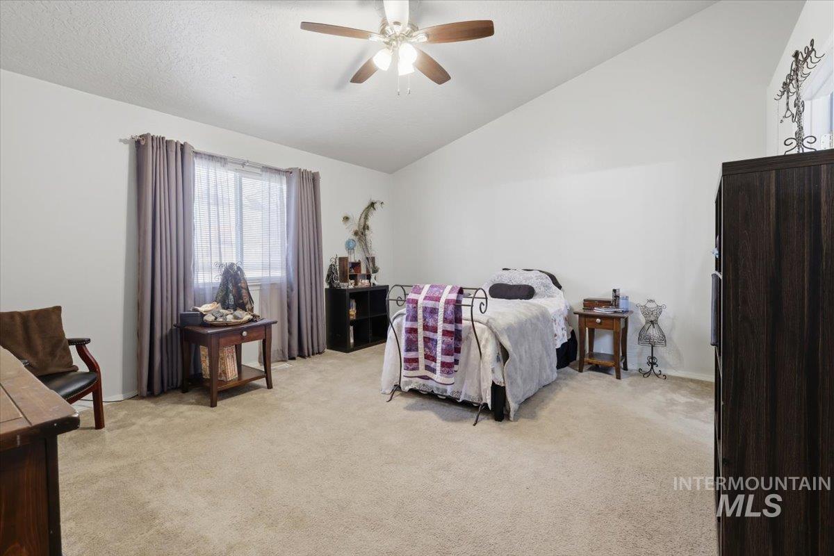 5002 Northrup Way Caldwell, ID 83607 - Photo 19 of 38 Bedroom featuring light carpet, a ceiling fan, and lofted ceiling