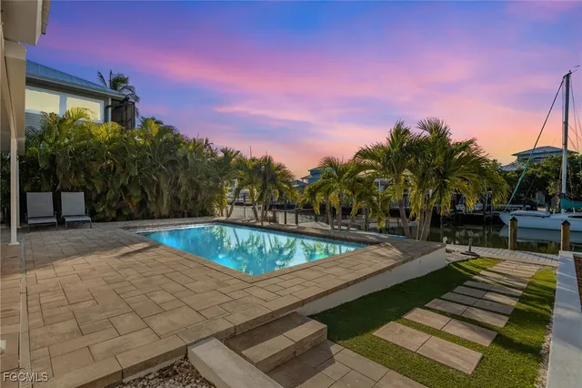 a view of swimming pool with chairs