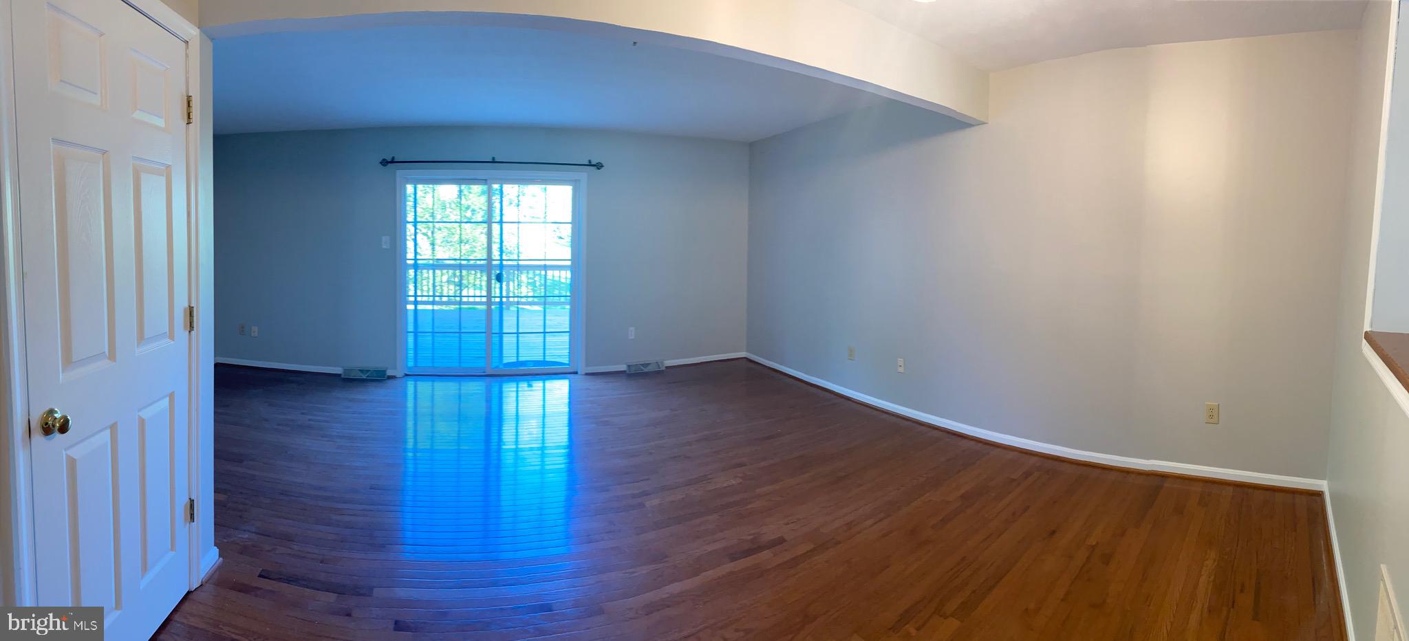 1216 Heathfield Road Eldersburg, MD 21784 - Photo 3 of 26 a view of an empty room with wooden floor and a window