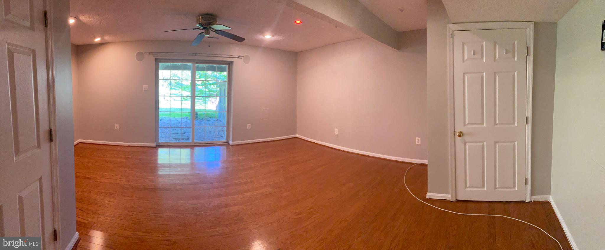 1216 Heathfield Road Eldersburg, MD 21784 - Photo 5 of 26 an empty room with wooden floor and a window