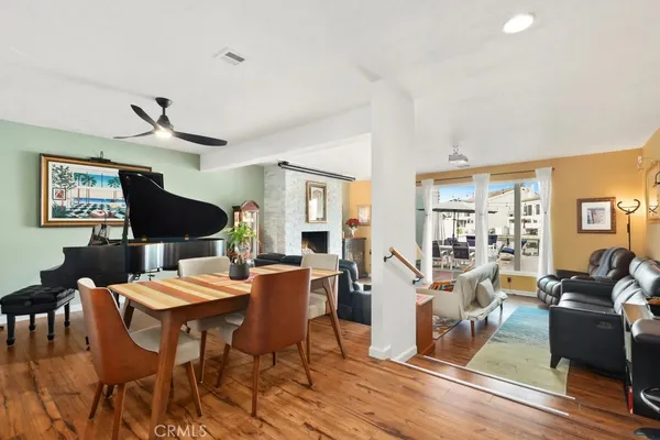 a living room with furniture a wooden floor and a chandelier