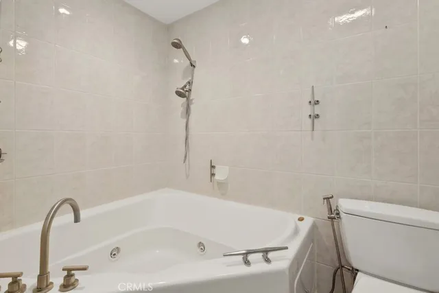 a bathroom with a white bath tub and a sink