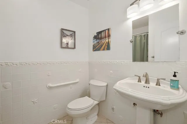 a bathroom with a sink toilet and a mirror