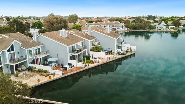 an aerial view of a house with swimming pool lake view and mountain view