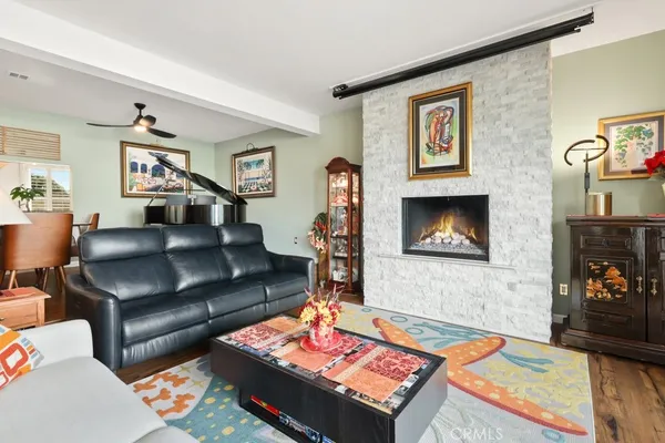 a living room with furniture fireplace and rug