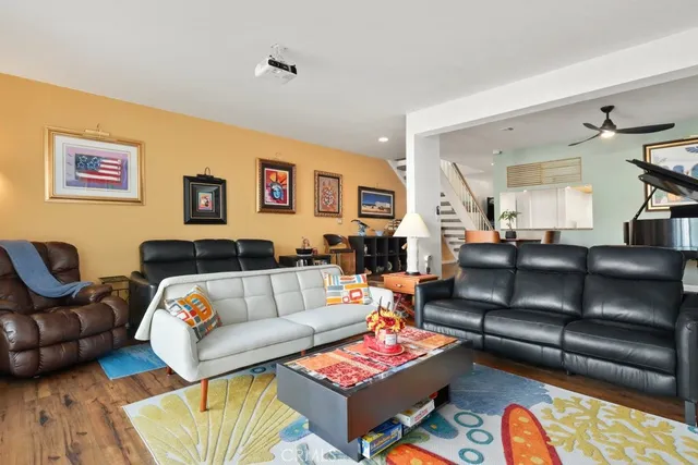 a living room with furniture a rug and a window