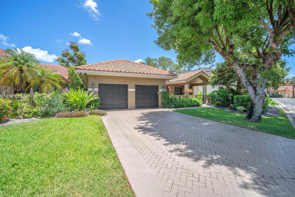 820 Southwest 87th Terrace Plantation, FL 33324 - Photo 15 of 41 a front view of a house with a yard and a garage
