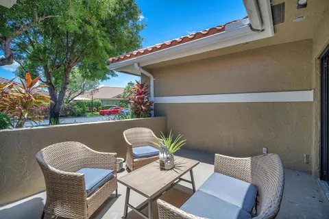 a view of a house with a yard and sitting area