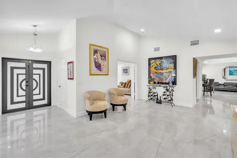 a living room with furniture and large window