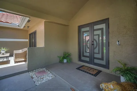 a view of a dining room with furniture and a chandelier fan