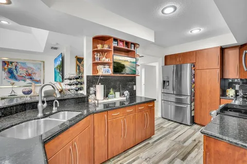 a bathroom with a granite countertop toilet sink and a shower